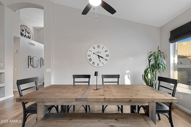 dining space with hardwood / wood-style floors and ceiling fan