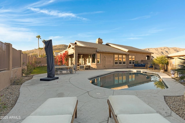 view of swimming pool featuring an outdoor living space, a patio, and a mountain view