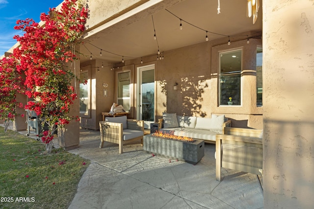 view of patio / terrace with an outdoor living space with a fire pit