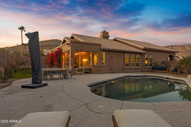 exterior space with a mountain view, an outdoor hangout area, and a patio