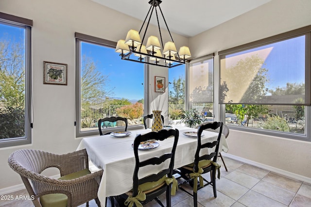 tiled dining room with an inviting chandelier