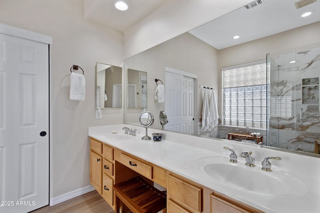 bathroom with walk in shower, hardwood / wood-style floors, and vanity