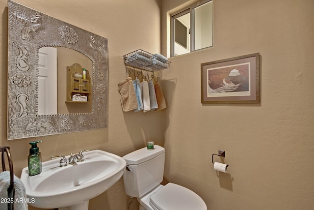 bathroom with toilet and sink