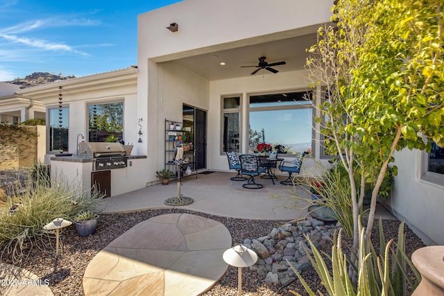 view of patio with area for grilling and ceiling fan