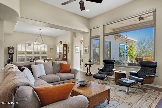 living room featuring ceiling fan, a wealth of natural light, and hardwood / wood-style flooring