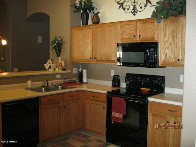 3871 E Ironhorse Rd, Gilbert, AZ 85297 - kitchen featuring black appliances, a sink, light countertops, and arched walkways