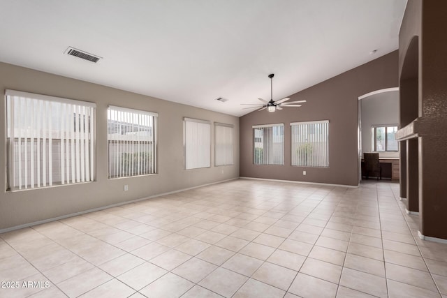 3871 E Ironhorse Rd, Gilbert, AZ 85297 - unfurnished room with vaulted ceiling, ceiling fan, arched walkways, light tile patterned floors, and baseboards