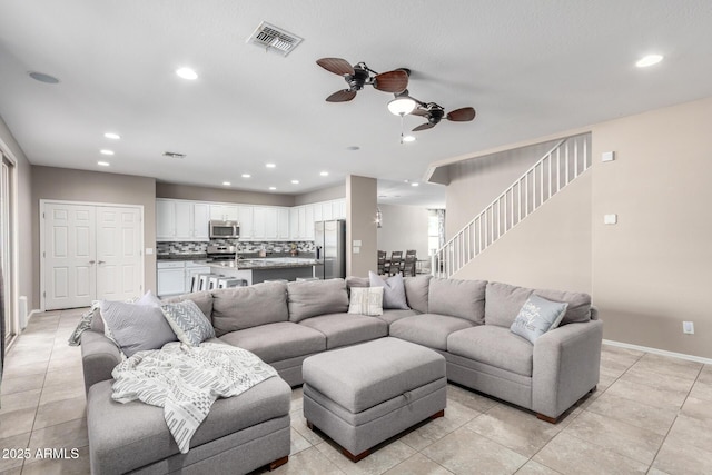 living room featuring recessed lighting, visible vents, stairway, and baseboards