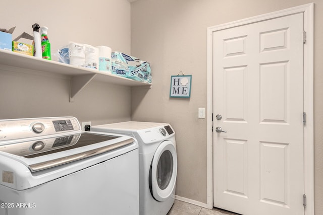 laundry area featuring laundry area, light tile patterned flooring, baseboards, and washing machine and clothes dryer