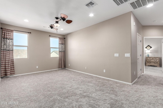 empty room featuring recessed lighting, light carpet, visible vents, baseboards, and a ceiling fan