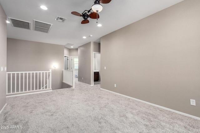 empty room with light carpet, visible vents, and recessed lighting