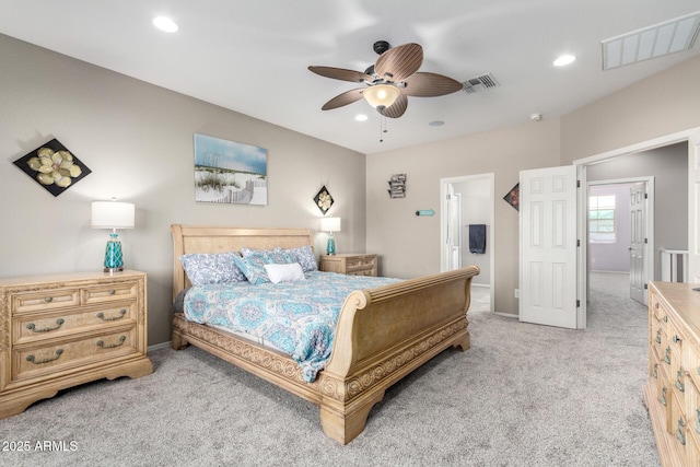 bedroom with light carpet, visible vents, and recessed lighting