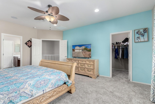 bedroom featuring light colored carpet, visible vents, baseboards, a spacious closet, and a closet