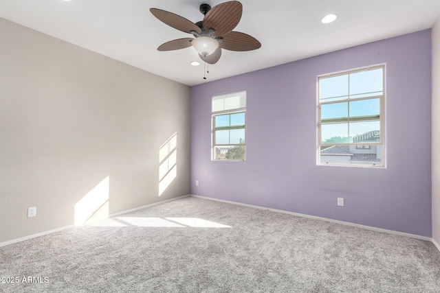 spare room with recessed lighting, light carpet, ceiling fan, and baseboards