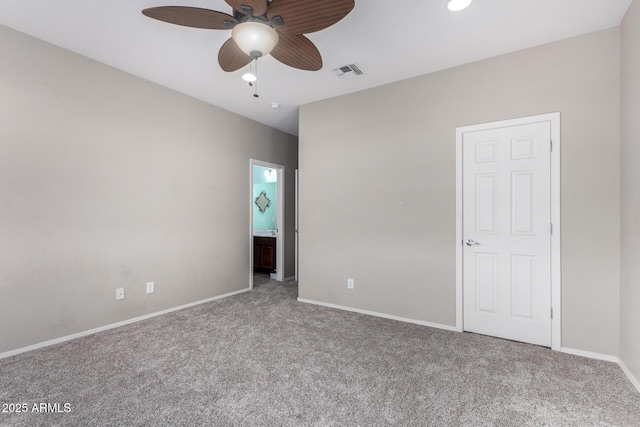 unfurnished bedroom with baseboards, visible vents, ensuite bath, and carpet flooring