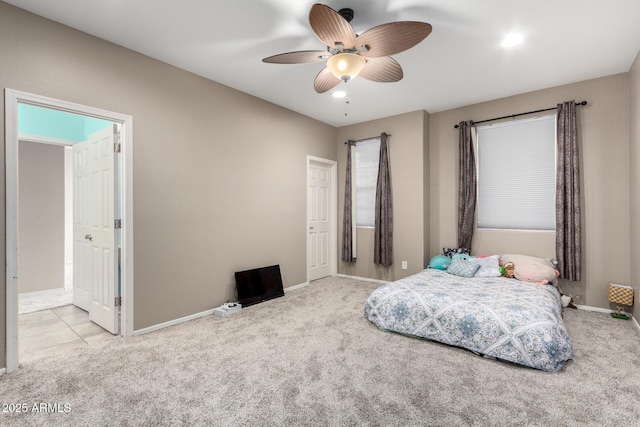 bedroom with baseboards, ceiling fan, and light colored carpet