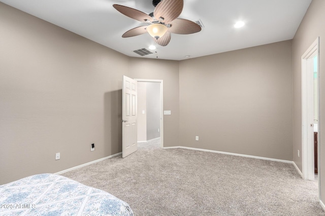 unfurnished bedroom with carpet floors, baseboards, and visible vents