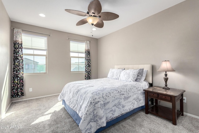 bedroom with ceiling fan, recessed lighting, light colored carpet, and baseboards