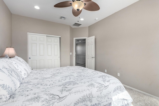 carpeted bedroom featuring a ceiling fan, a closet, visible vents, and baseboards