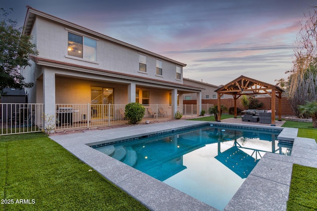 pool at dusk featuring a fenced in pool, a patio, a fenced backyard, a jacuzzi, and a gazebo