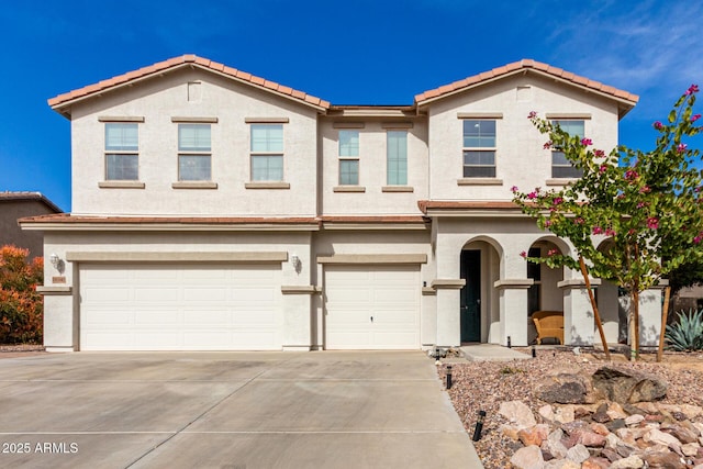 view of front of property featuring a garage, driveway, and stucco siding