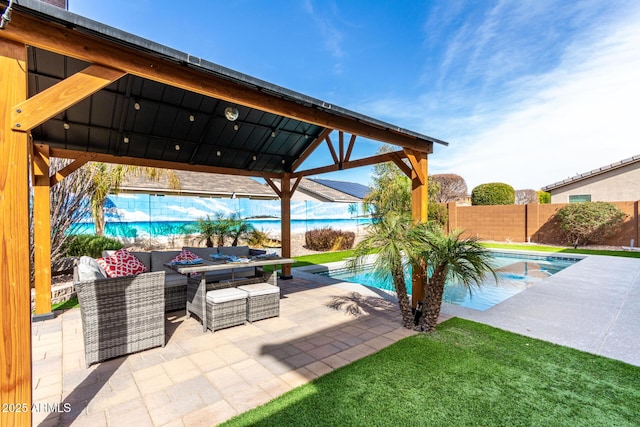 view of swimming pool featuring a fenced in pool, outdoor lounge area, a patio, and a fenced backyard