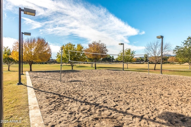 view of community featuring a lawn and volleyball court