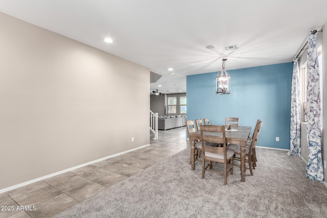 dining room with baseboards, carpet, visible vents, and an inviting chandelier