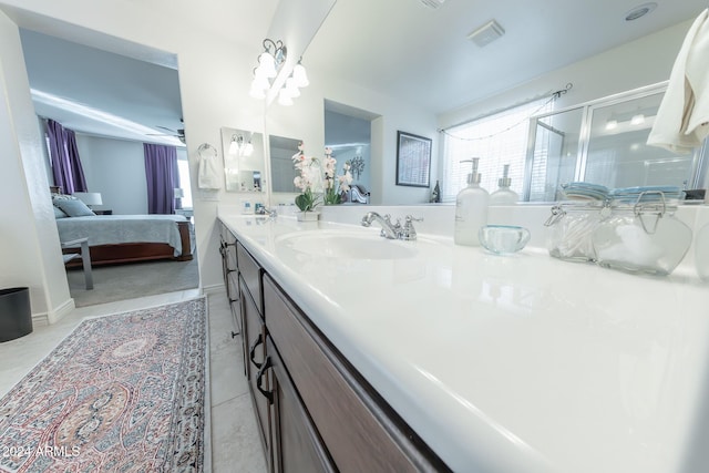 bathroom featuring tile patterned flooring, vanity, ceiling fan, and a shower with shower door