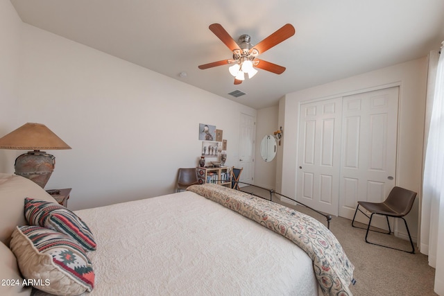 carpeted bedroom with ceiling fan and a closet