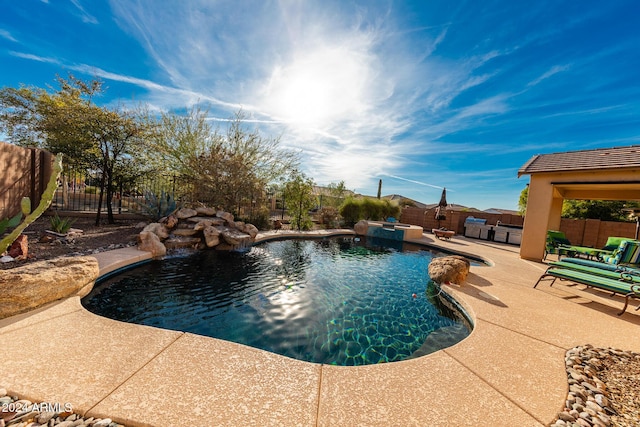 view of pool featuring pool water feature and a patio