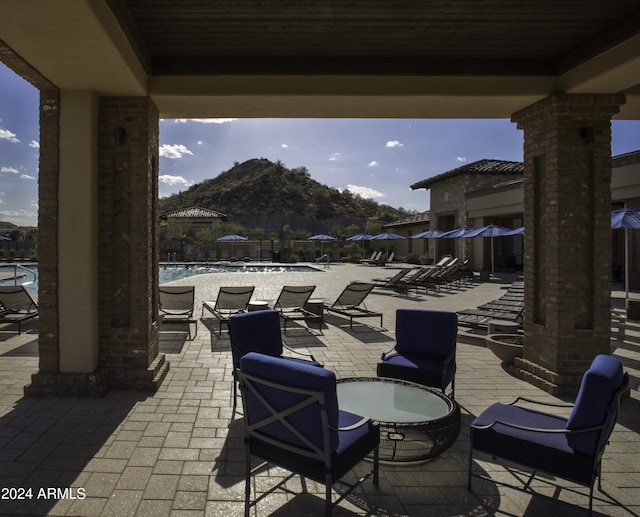 view of patio / terrace featuring a mountain view and a community pool