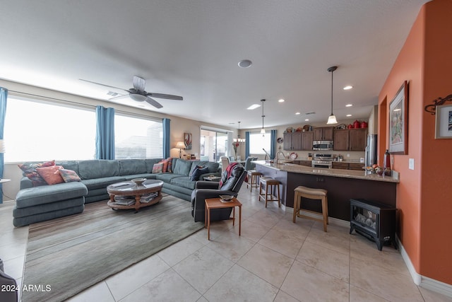 living room with light tile patterned floors and ceiling fan