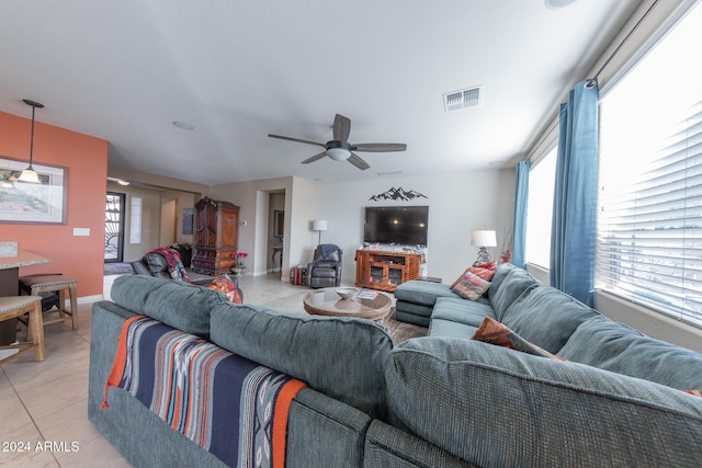 living room with light tile patterned flooring and ceiling fan