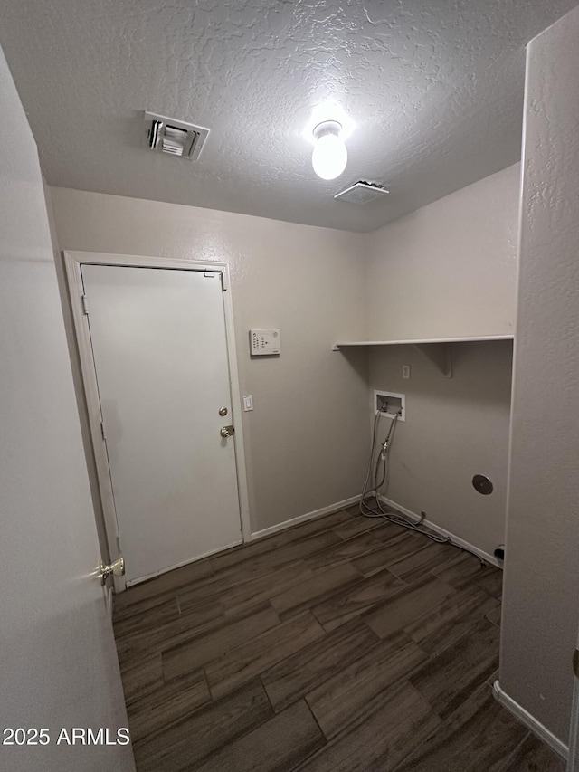 clothes washing area with a textured ceiling, dark wood-style flooring, visible vents, washer hookup, and laundry area