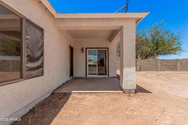 4561 E Red Bird Ln, San Tan Valley, AZ 85140 - view of exterior entry with stucco siding and a patio