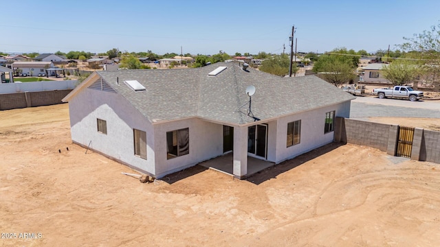 4561 E Red Bird Ln, San Tan Valley, AZ 85140 - back of property with stucco siding, roof with shingles, a gate, and a residential view