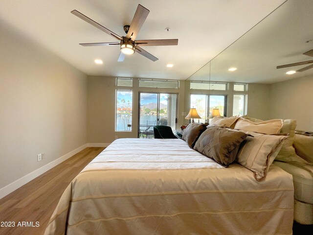 bedroom with light wood-type flooring, access to outside, and ceiling fan