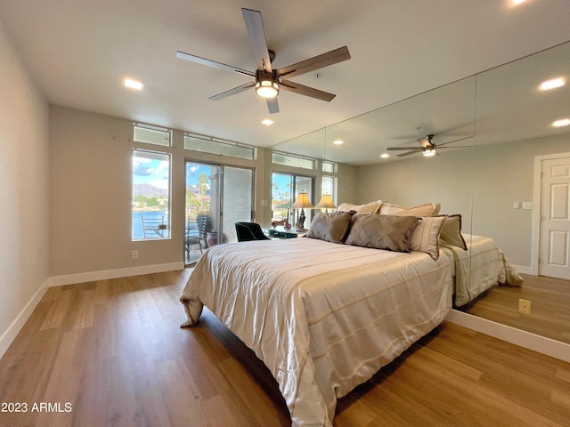 bedroom featuring access to exterior, hardwood / wood-style floors, and ceiling fan