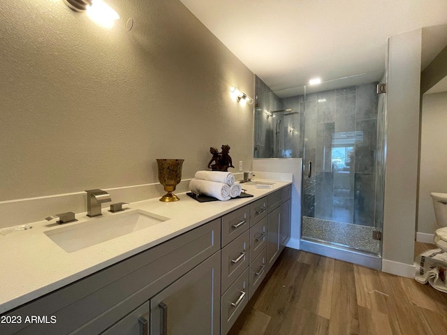 bathroom with hardwood / wood-style floors, vanity, and walk in shower