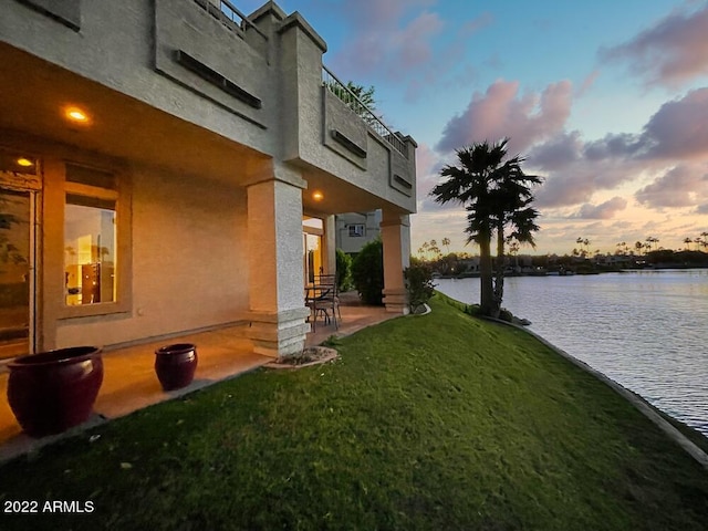 yard at dusk with a water view