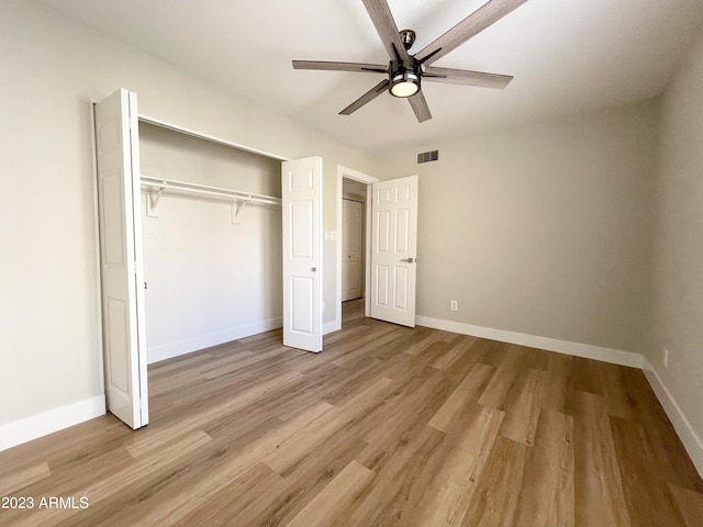 unfurnished bedroom featuring a closet, light hardwood / wood-style flooring, and ceiling fan