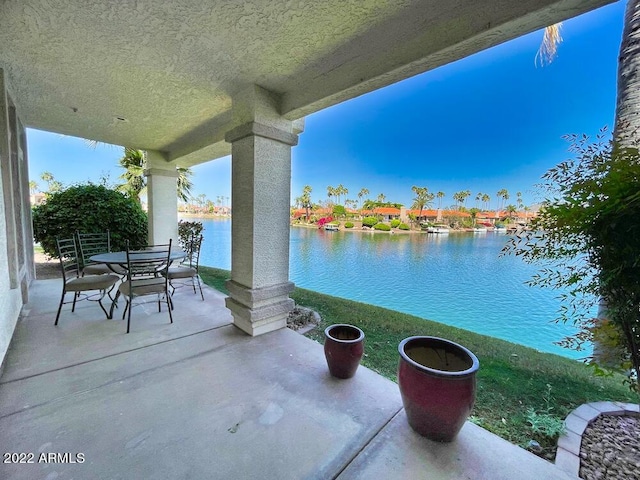 view of patio with a water view