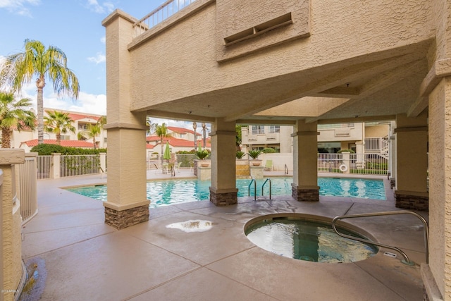 view of swimming pool featuring a community hot tub