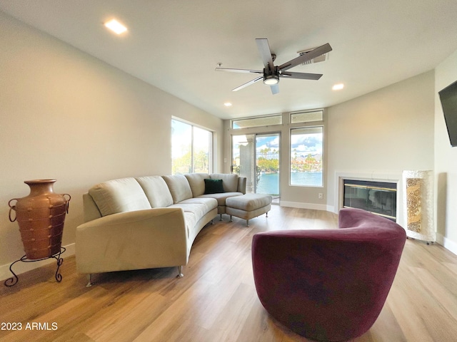 living room featuring light wood-type flooring and ceiling fan