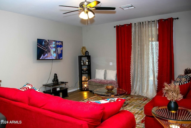 living room featuring ceiling fan and hardwood / wood-style flooring