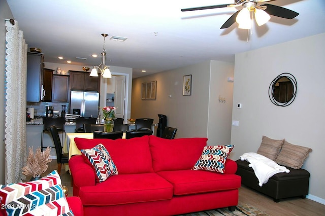 living room featuring ceiling fan and wood-type flooring