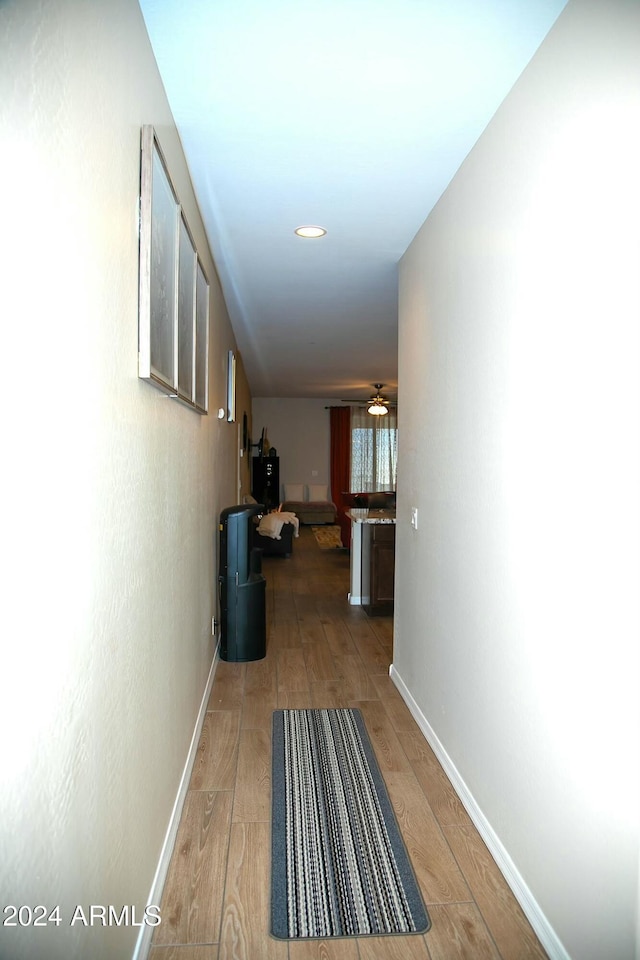 corridor with hardwood / wood-style flooring