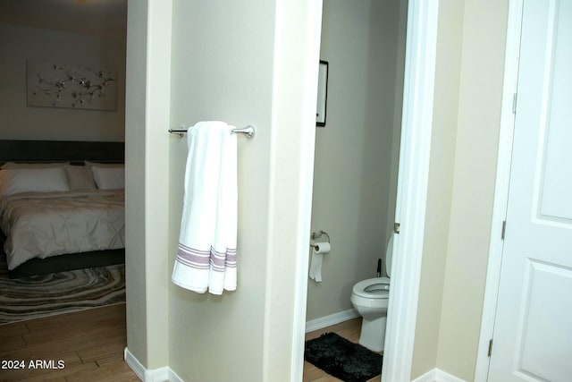 bathroom featuring toilet and wood-type flooring