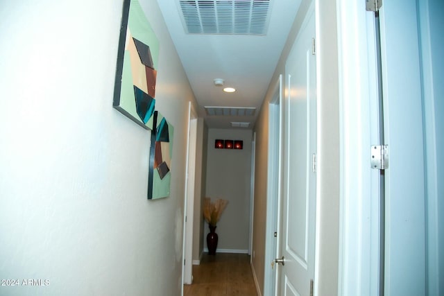 hallway with hardwood / wood-style floors